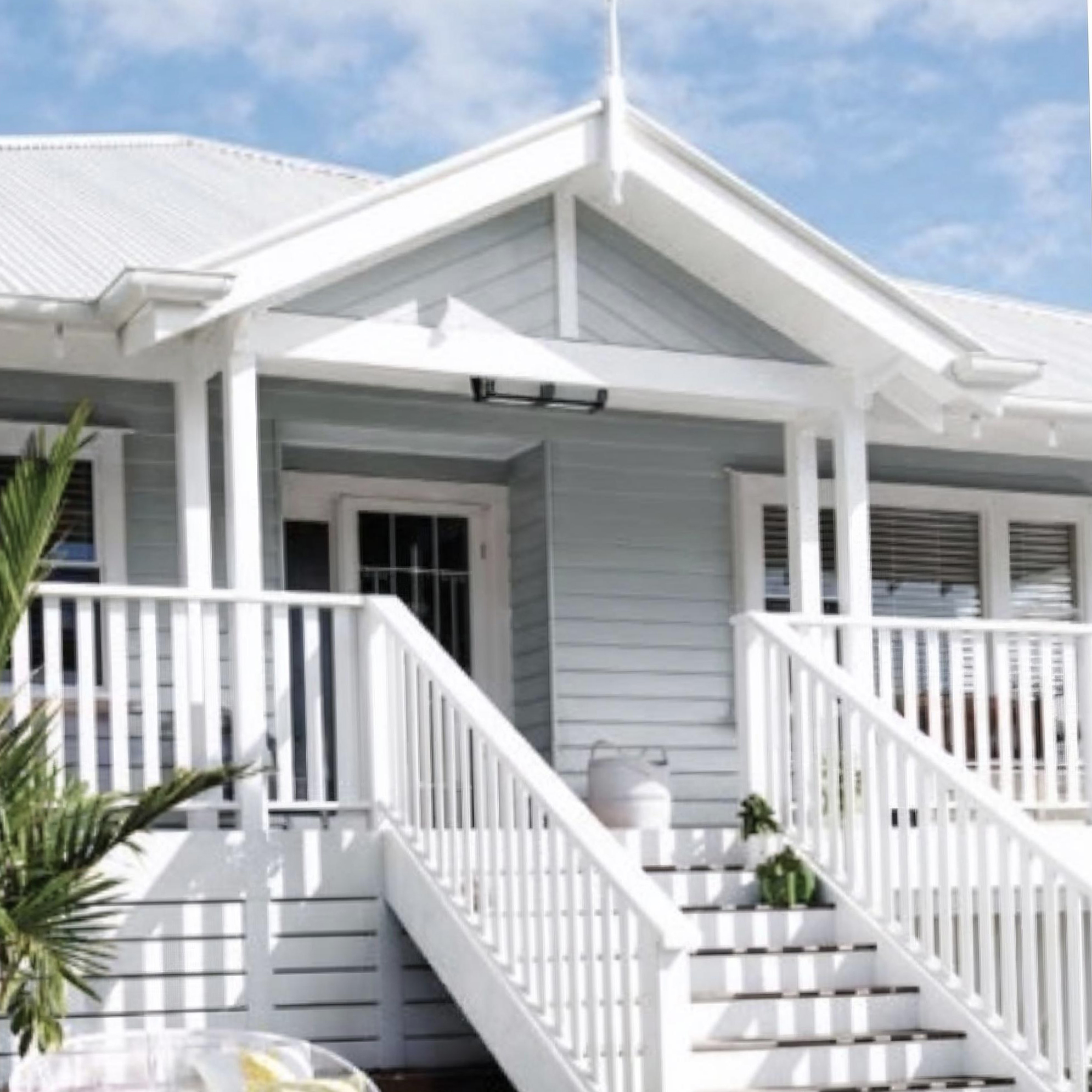 Painted weatherboard exterior with white deck railing